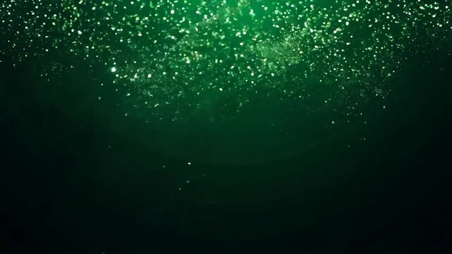 a seamless looping video of vibrant green glitter particles gently falling against a black background
