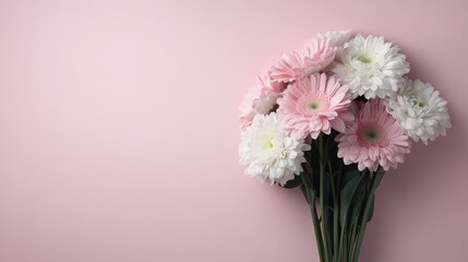 A simple yet elegant bouquet of light pink and white flowers arranged against a pastel pink background, showcasing the soft and delicate beauty of the flowers.