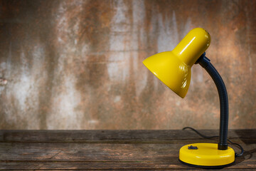 A table lamp on old boards against a shabby background