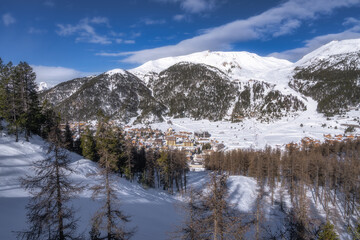 View on beautiful Montgenevre ski village in the valley on the border of France and Italy in Cottian Alps. Winter sport in snowy mountains