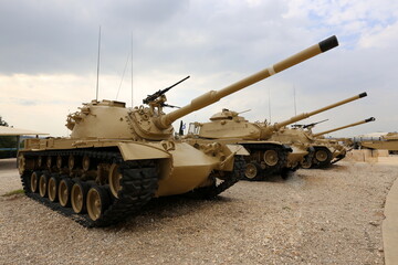 An old tank stands on the side of the road.