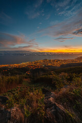 beautiful sunset over the city of Funchal on Madeira from the location Miradouro do Pico Alto. Mountains landscape