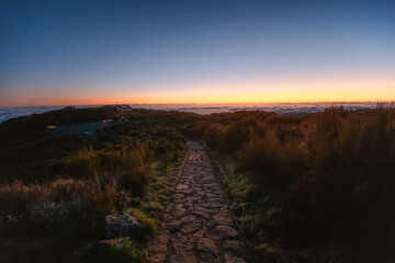 Hiking on the highest peak of Madeira Pico Ruivo next to the cottage Abrigo do Pico Ruivo. Views of...