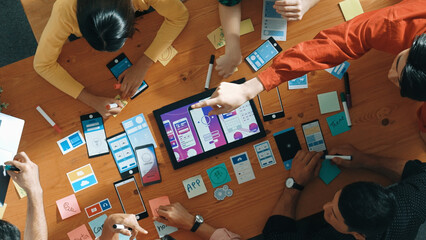 Top down view of business team writing idea on sticky note while planing for Ux Ui design for...