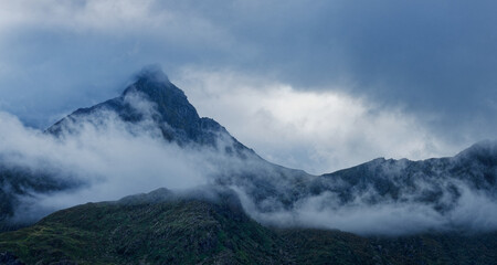 Mountains covered in fog and clouds on a cloudy day. Lofoten Norway. 