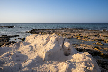 Rocky coast of a public beach, Djerba, Tunisia
