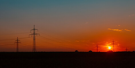 Summer sunset with overland high voltage lines near Tabertshausen, Aholming, Deggendorf, Bavaria, Germany