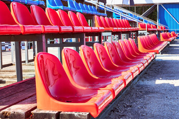 Fototapeta premium a view of the plastic red seats in the grandstand