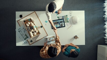 Top view of skilled architect engineer working together and shaking hand cooperative team while...