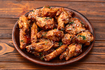 Caramelized in sause chicken wings  . Bar-b-q food background photo