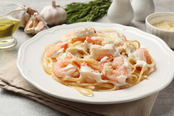 Delicious pasta with shrimps served on light table, closeup