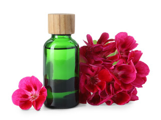 Geranium essential oil in bottle and beautiful flowers isolated on white