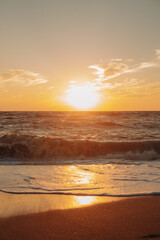 Sunset at sea during a storm. Coast with waves in sea on sunset. Waves in sea during storm and wind. Wave from the sea goes on land to the beach. Splashing Waves, Seaside. vertical