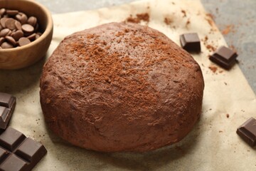 Chocolate dough and ingredients on grey table, closeup