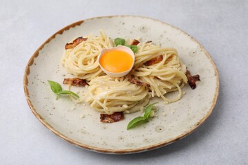 Delicious pasta Carbonara on grey table, closeup