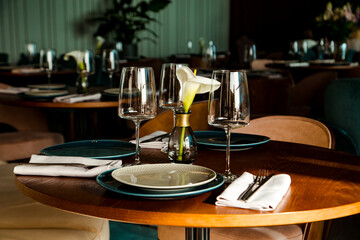 Stylish table setting in a cozy restaurant with dishes and furniture.in a minimalist style