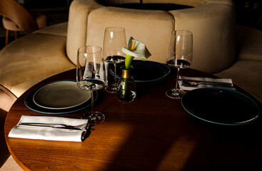 Stylish table setting in a cozy restaurant with dishes and furniture.in a minimalist style