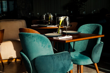 Stylish table setting in a cozy restaurant with dishes and furniture.in a minimalist style