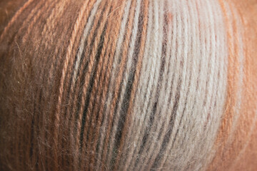 Colourful ball of yarn, close up. Warm wool yarn in gradient colors. Knitting hobby. Handiwork store. Knit background. Handcraft concept. Knit pattern.