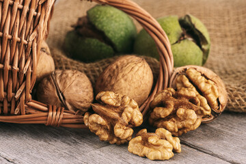 Walnut kernels and whole walnuts on rustic wooden table. Healthy walnuts.