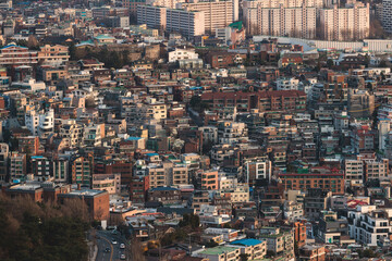 Beautiful vibrant aerial sunset view of Seoul, South Korea skyline, with mountains and sprin scenery beyond the city, seen from observation deck of Namsan Park, Gyeonggi-do province, Republic of Korea