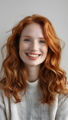 Fototapeta premium Adult female with ginger hair smiling into a camera. Isolated background with copy space.