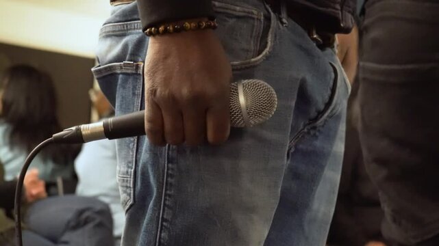 Blackman holding a microphone