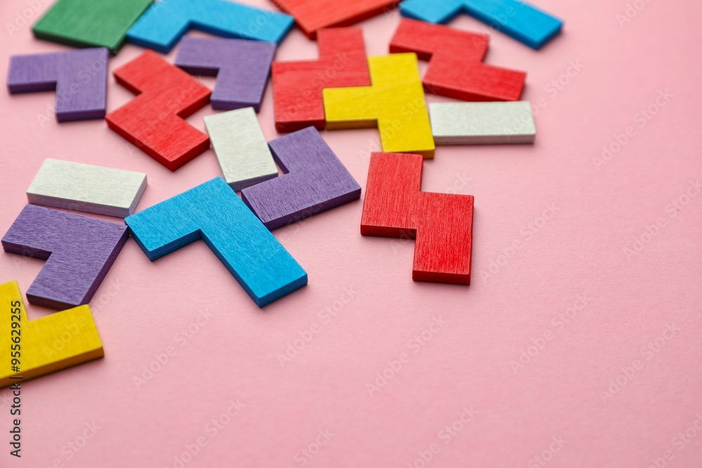 Canvas Prints Colorful wooden puzzle pieces on pink background. Space for text