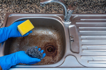 Should you use a sponge or steel wool to clean dirty kitchen sinks