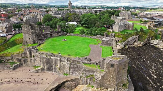 Aerial view of Coastal, episcopal castle ruins with secret passages and dungeon in Scotland. St Andrews Castle residence of Scotland's leading bishop, cathedral and town of St Andrews view.
