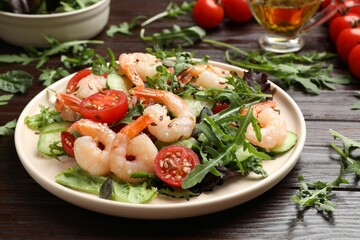 Delicious shrimp salad with vegetables on wooden table, closeup