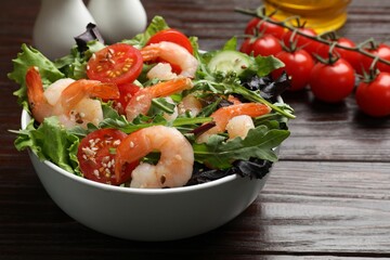 Delicious shrimp salad with vegetables on wooden table, closeup