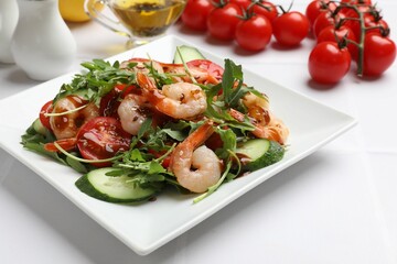 Delicious shrimp salad with vegetables on white table
