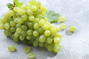 Fresh ripe grapes on grey table, closeup