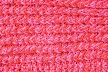 Texture of bright knitted fabric as background, top view