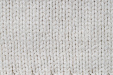 Texture of white knitted fabric as background, top view