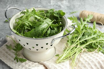 Fresh green arugula leaves on grey table