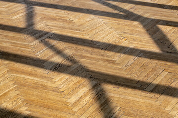 Abstract background with straight shadows on old wooden parquet.