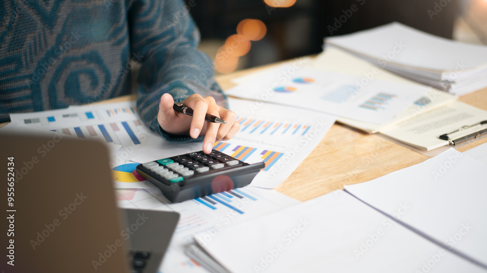 Poster businessman calculating figures in company financial documents with a calculator,analysis of company