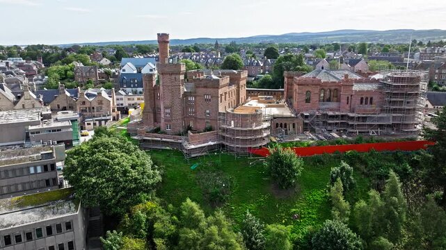 Aerial view of Inverness Castle. Red sandstone castle overlooking the cliffs. Drone view of Old Town on Scotland&rsquo;s northeast coast, where the River Ness meets the Moray Firth, United Kingdom.