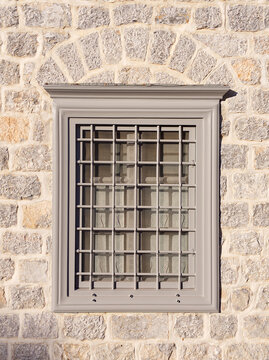 Front-view of window close-up facade in stone wall 
