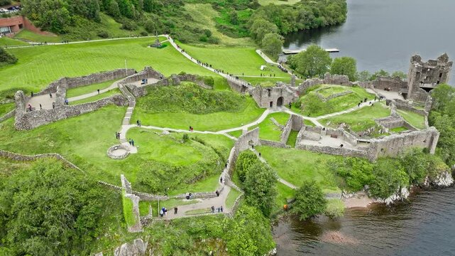Aerial view of Urquhart Castle Large, ruined castle overlooking Loch Ness. The fortress situated on a headland, medial ruin in the Scottish Highlands laid out around two main enclosures on the shore.