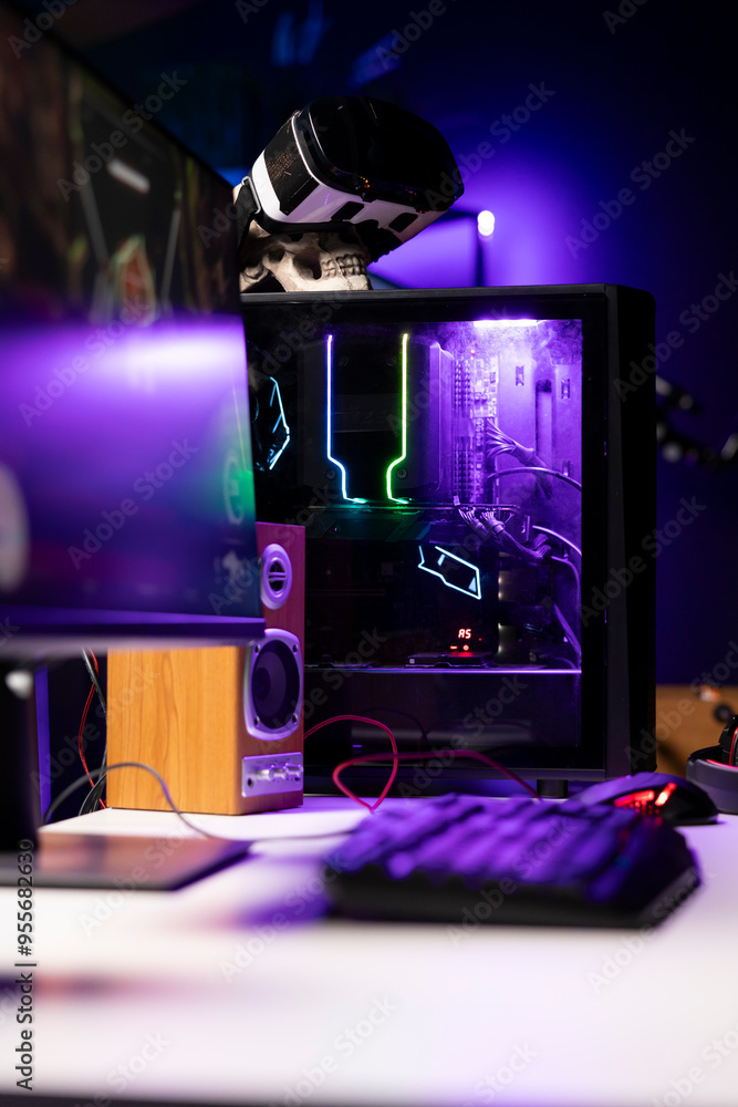 Poster rgb lights illuminated components on open gaming pc tower next to computer peripherals, display and 