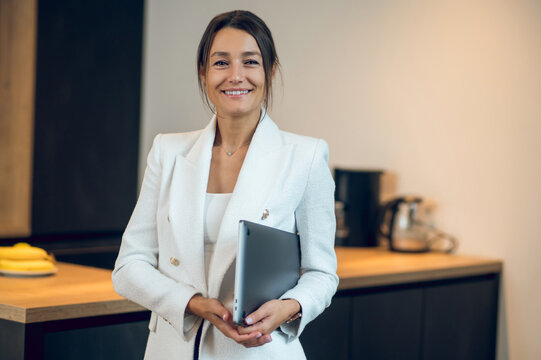 Pretty business woman in white jacket looking confident and determined