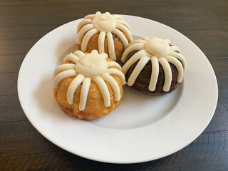 Three frosted mini Bundt cakes. Individual serving muffin cakes.