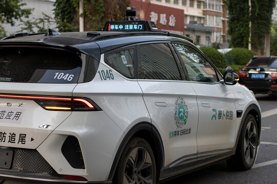 Wuhan, Hubei, China - July 12, 2024: Chinese tech company Baidu's self-driving electric robotaxi is seen on the streets in the Qiaokou District of Wuhan.
