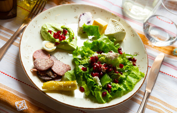 Appetizing Albanian appetizers of light vegetable salad, a mix of djatrash and Salсe Kosi sauce