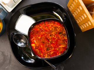 National dish of Russian cuisine is Solyanka soup, served with sour cream