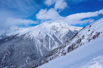 Obraz premium Downhill skiing resort in high mountains, aerial view