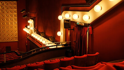 Rows Of Red Seats Are Illuminated By Lights In An Empty Theater Or Cinema.